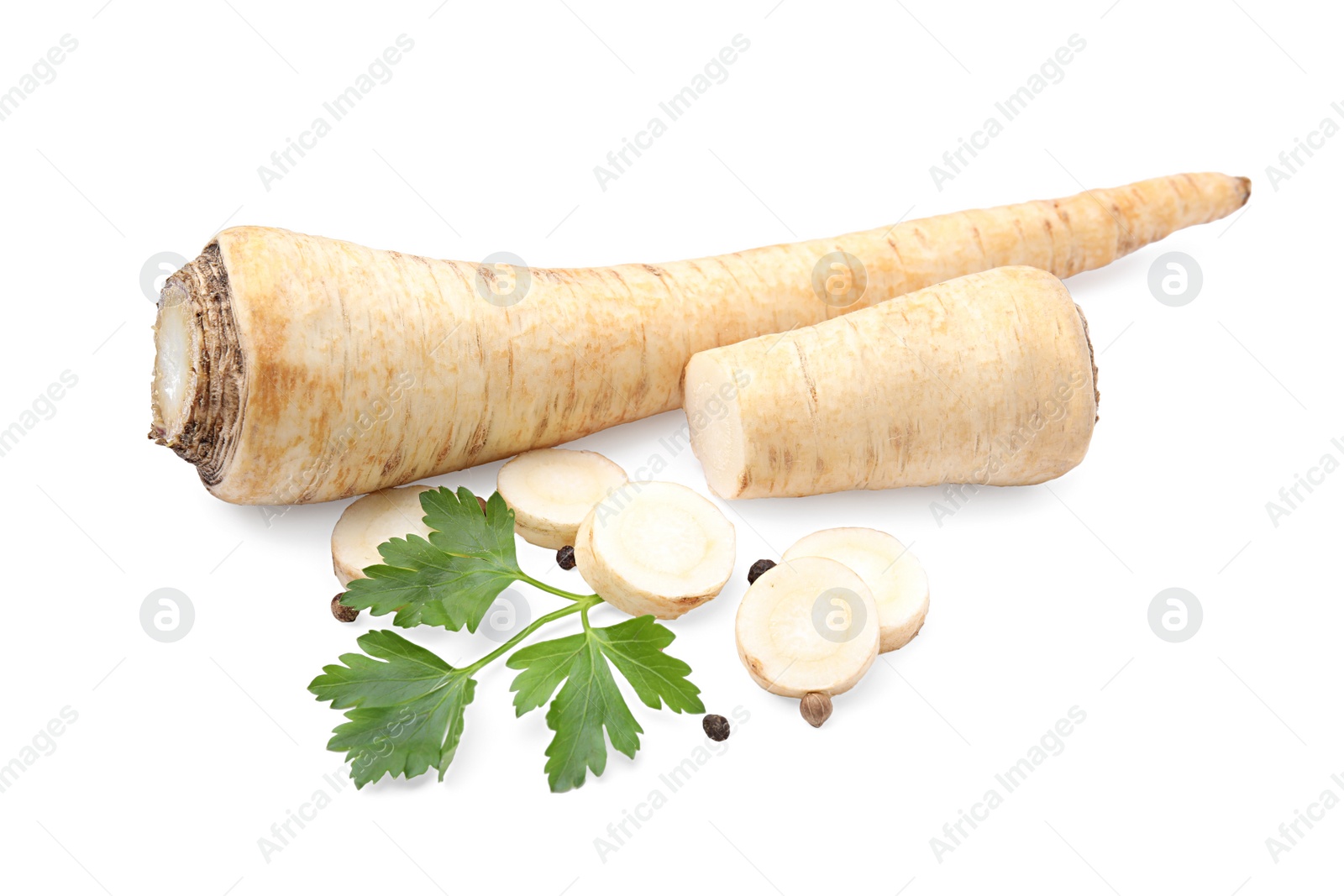 Photo of Whole and cut raw parsley roots, fresh herb isolated on white