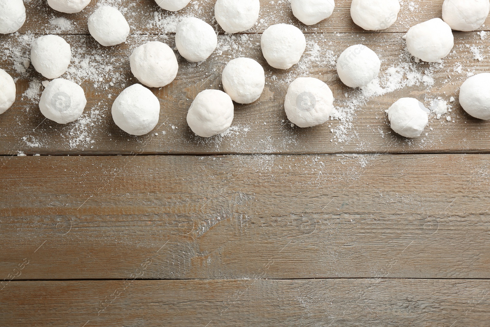 Photo of Snowballs on wooden background, flat lay. Space for text