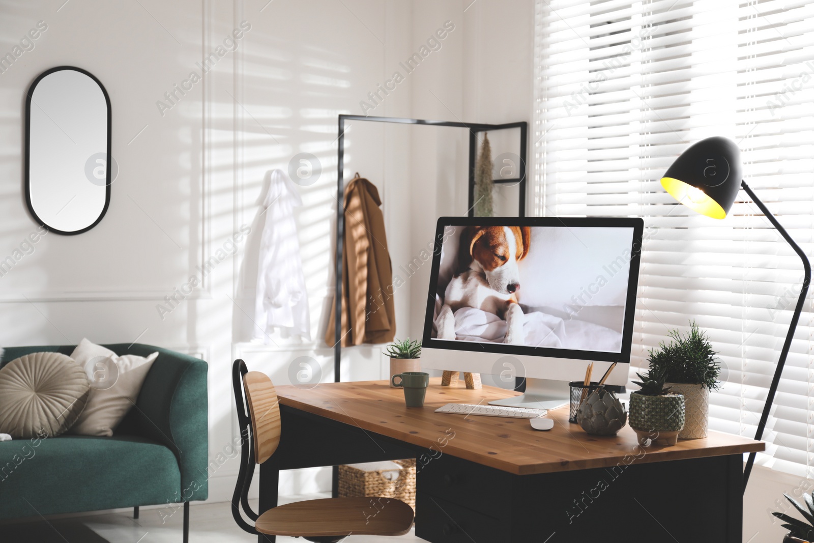 Photo of Stylish home office interior with sofa and comfortable workplace