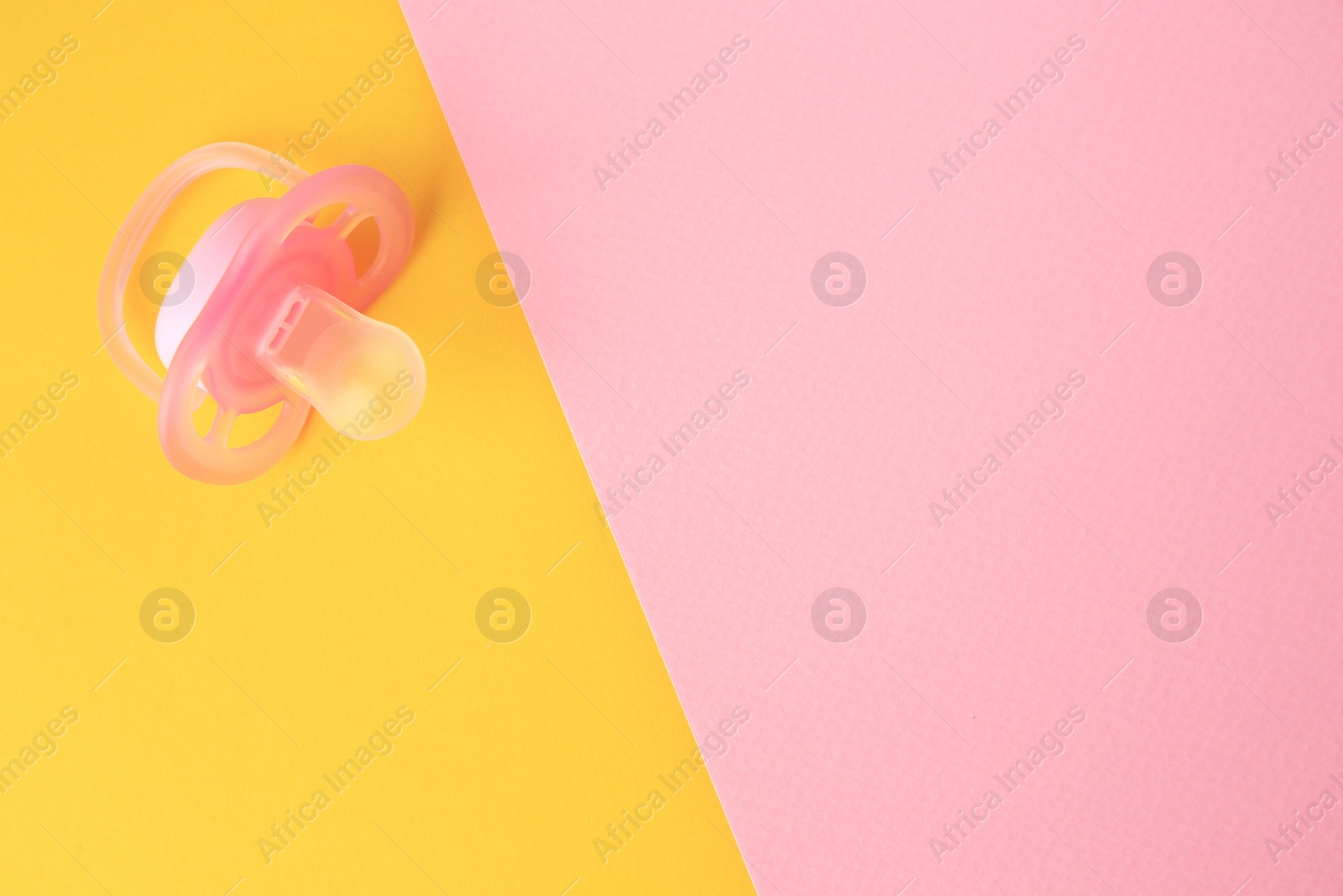 Photo of New baby pacifier on color background, top view. Space for text