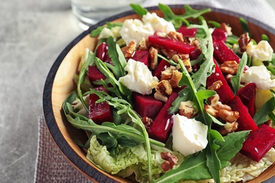 Photo of Bowl with tasty beets salad on table