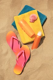 Flat lay composition with sunscreens on sand. Sun protection care