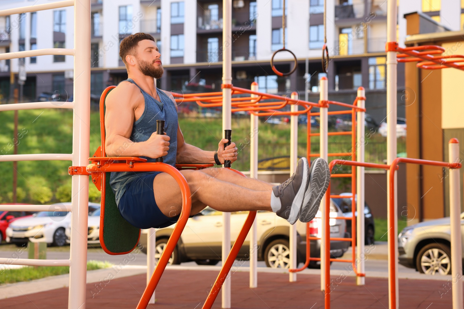 Photo of Man training on abs station at outdoor gym