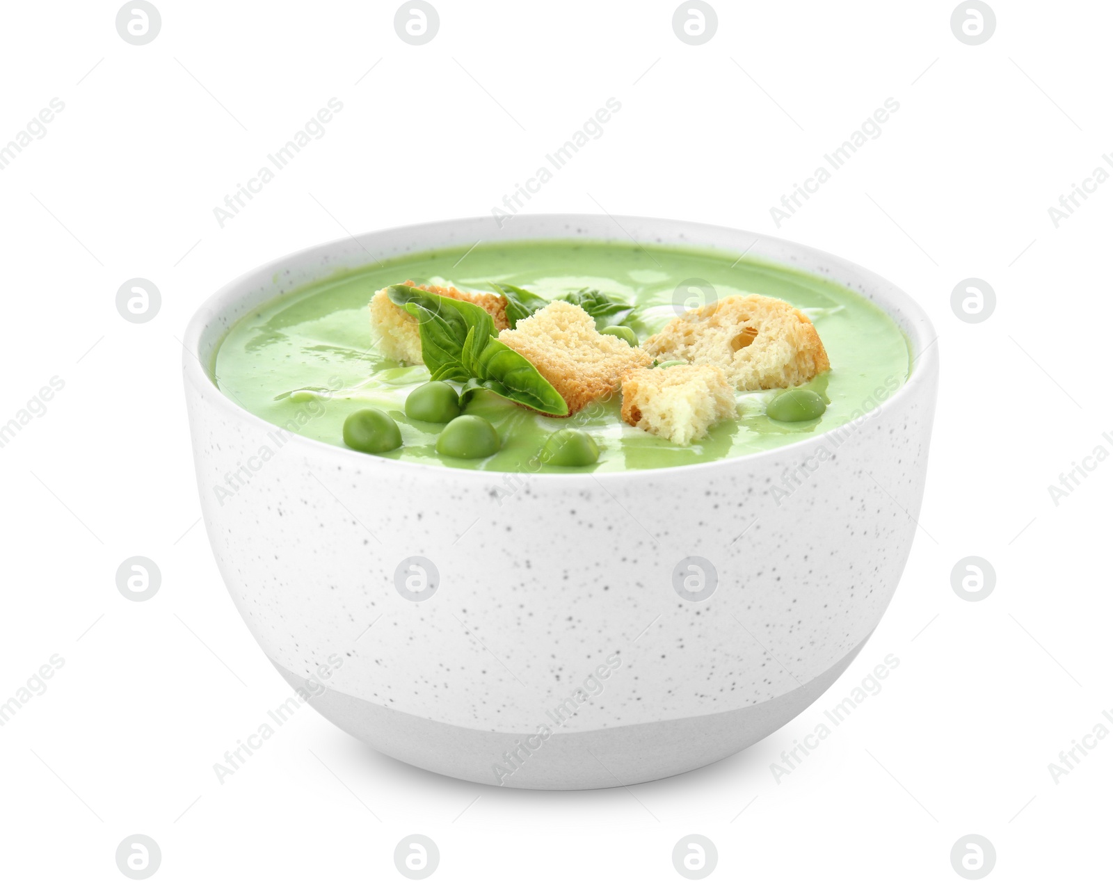 Photo of Green pea soup with croutons in bowl on white background