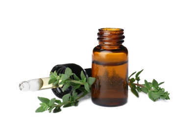 Photo of Bottle with thyme essential oil and fresh herb on white background