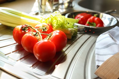 Photo of Fresh tomatoes and celery on countertop in kitchen