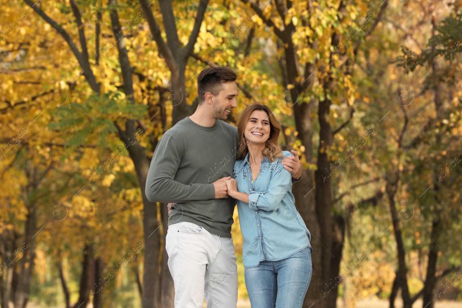 Photo of Happy lovely couple on walk in autumn park