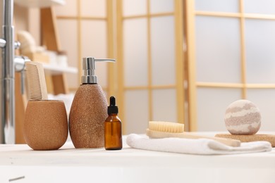 Photo of Different personal care products and accessories on bath tub in bathroom, closeup