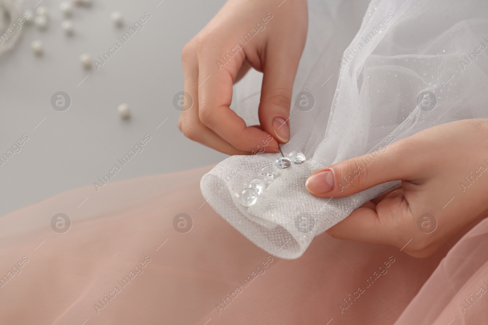 Photo of Dressmaker creating new dress in atelier, closeup