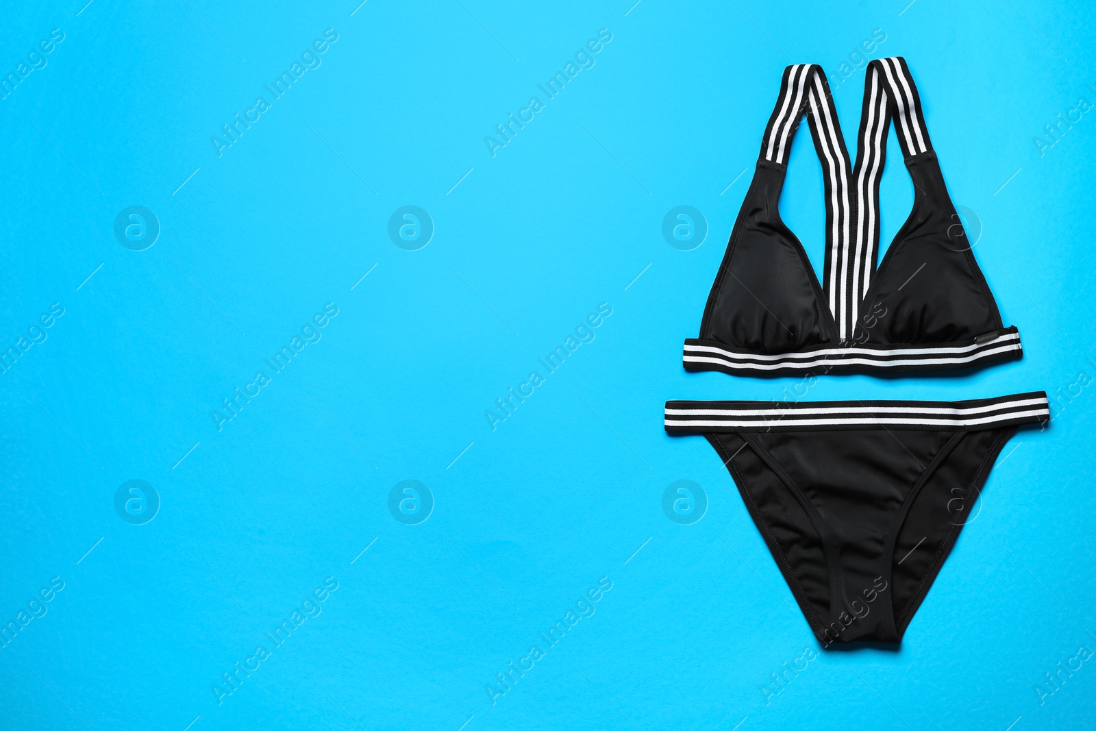 Photo of Stylish bikini on color background, top view