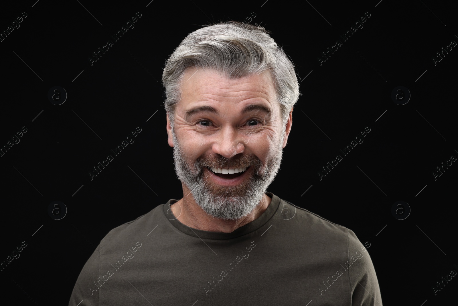 Photo of Personality concept. Portrait of happy man on black background