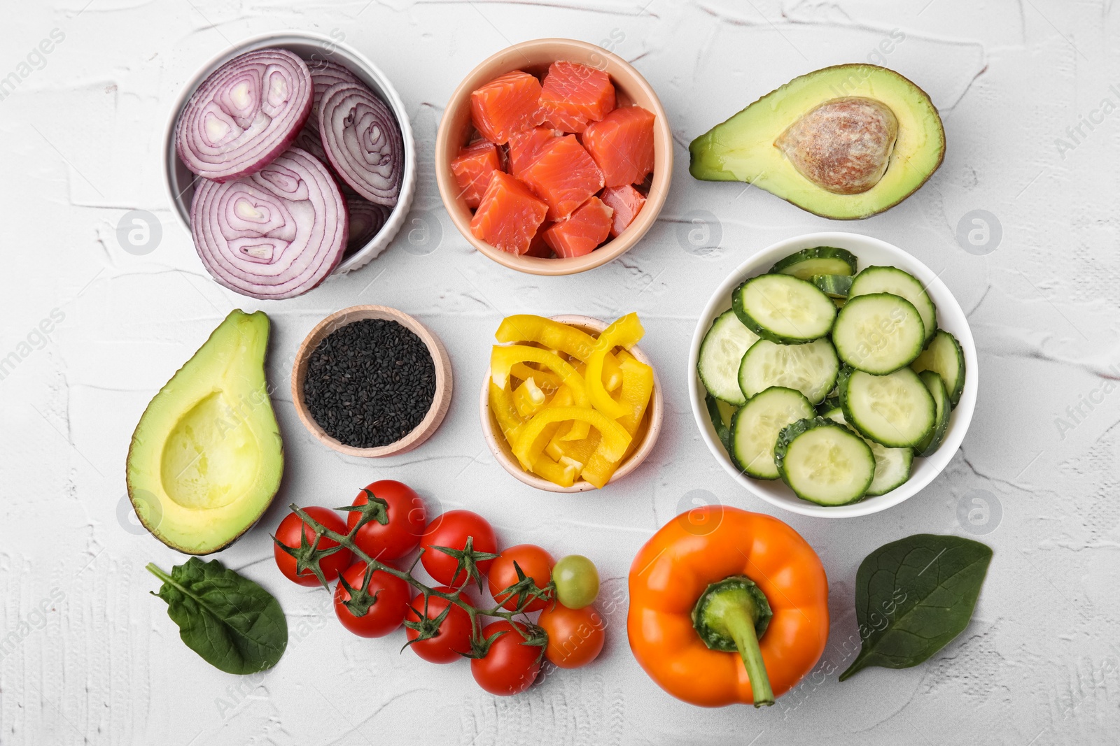 Photo of Ingredients for poke bowl on white textured table, flat lay