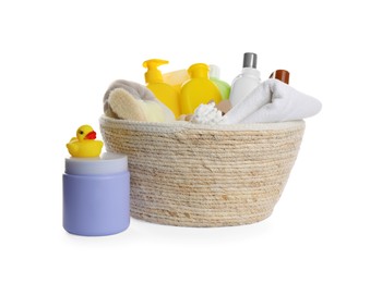 Wicker basket full of different baby cosmetic products, bathing accessories and toys on white background