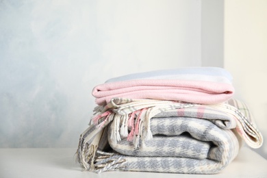 Stack of soft plaids on white table