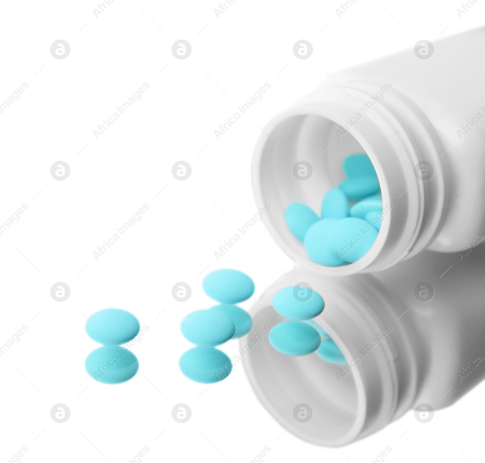 Photo of Bottle with pills on mirror surface