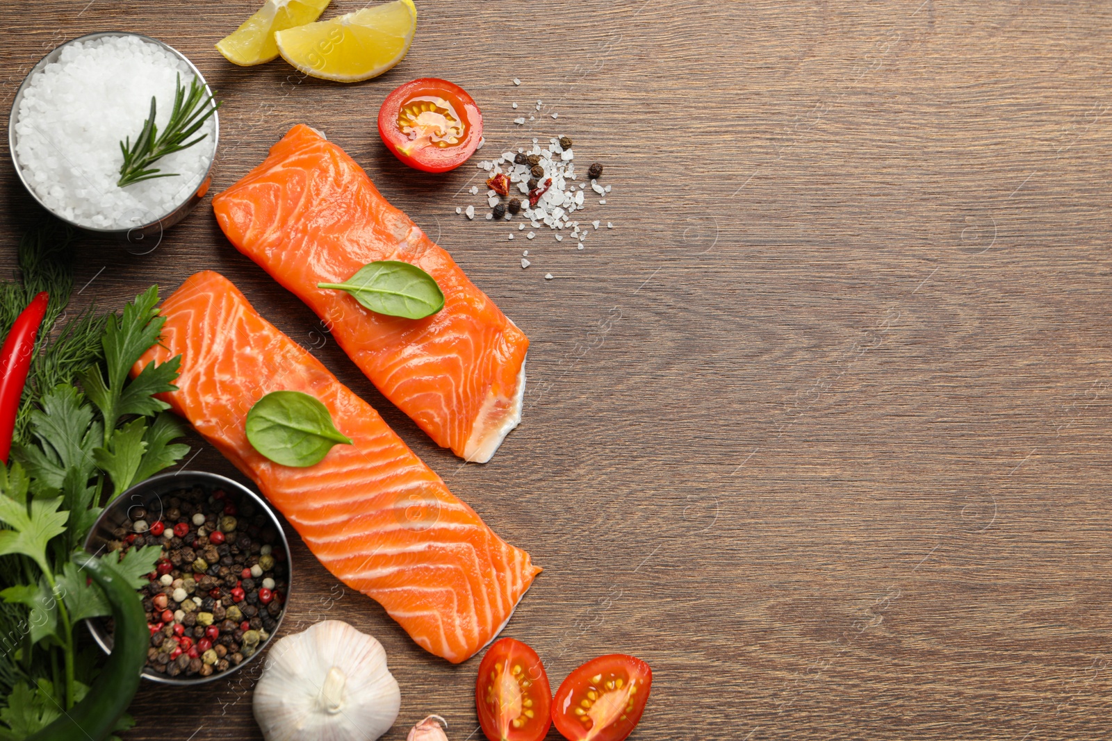 Photo of Fresh salmon and ingredients for marinade on wooden table, flat lay. Space for text