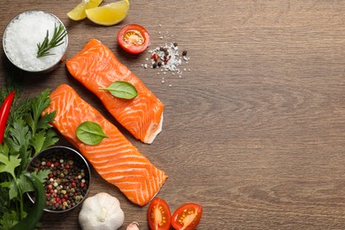 Photo of Fresh salmon and ingredients for marinade on wooden table, flat lay. Space for text