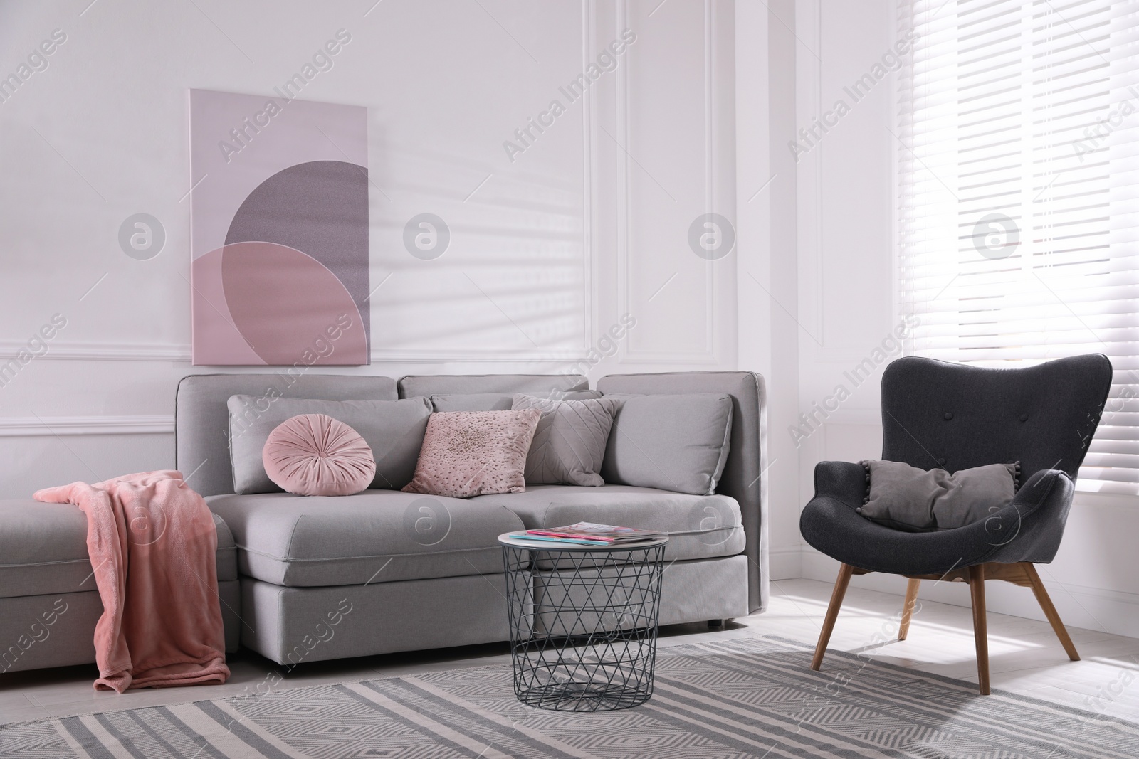 Photo of Cozy living room interior with comfortable grey sofa and armchair