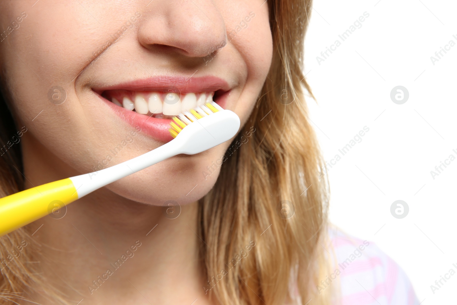 Photo of Young woman with toothbrush on white background, closeup. Space for text