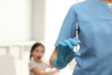 Doctor with syringe in clinic, closeup. Vaccination day