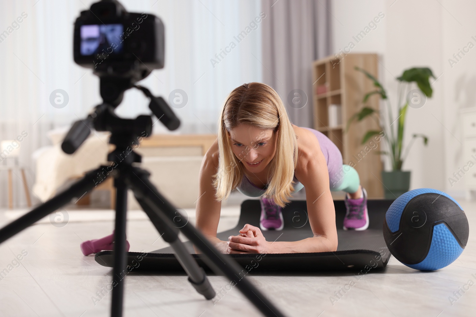 Photo of Fitness trainer recording online classes at home