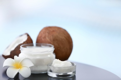 Composition with coconut butter in glass jar on blurred background