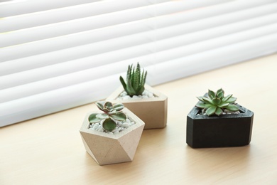 Photo of Window with blinds and potted plants on sill