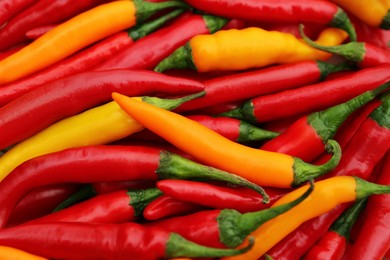 Photo of Yellow and red hot chili peppers as background, closeup