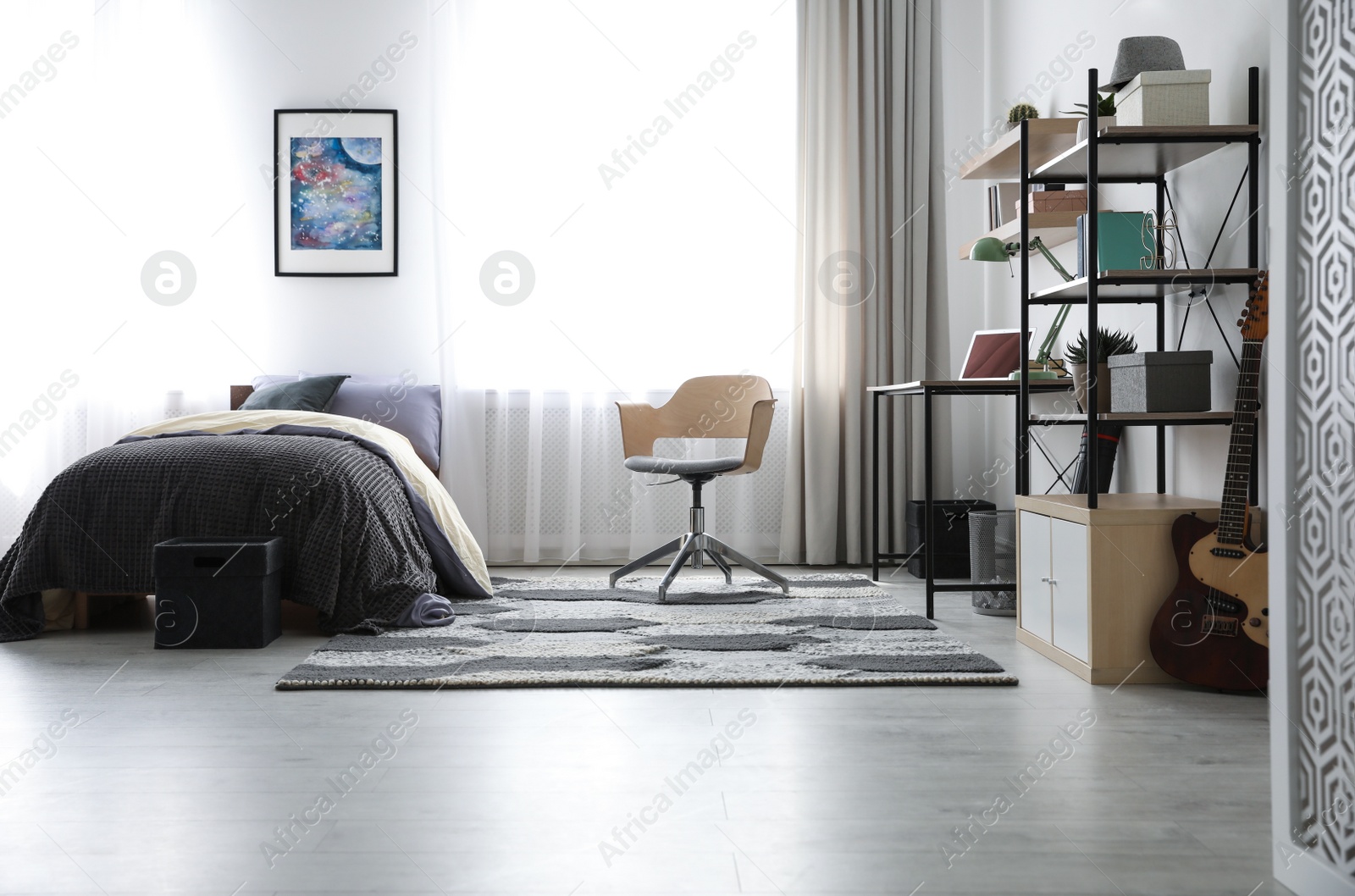 Photo of Modern teenager's room interior with workplace and bed