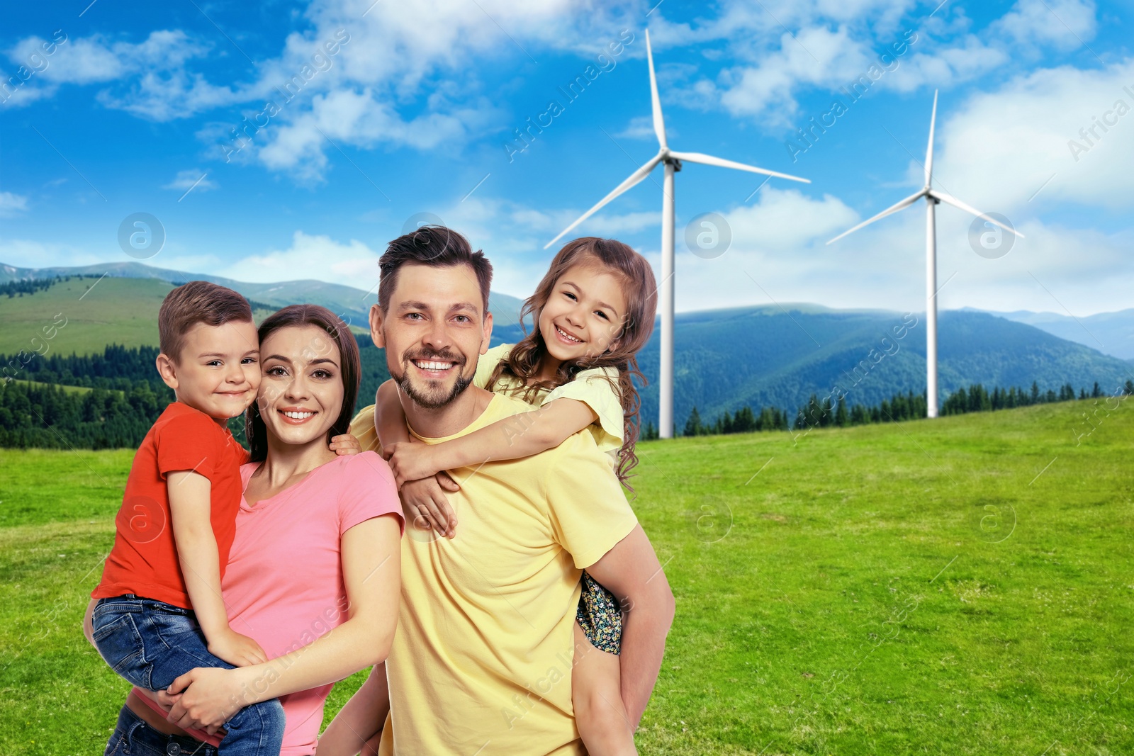 Image of Happy family with children and view of wind energy turbines on sunny day