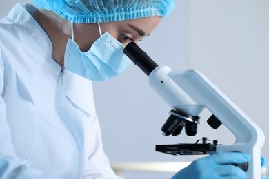 Photo of Scientist working with microscope on blurred background, closeup. Medical research