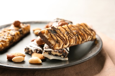 Homemade grain cereal bars with chocolate and nuts on plate