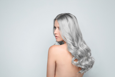 Image of Woman with gray hair on light background