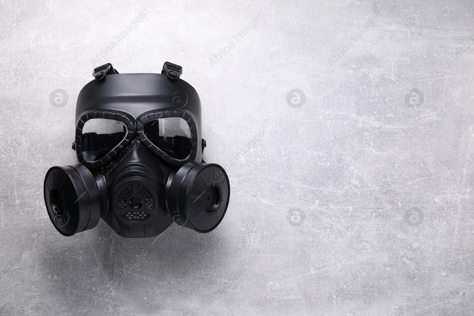 Photo of One gas mask on grey textured background, top view. Space for text