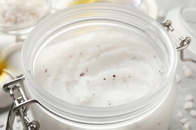 Body scrub in glass jar, closeup view