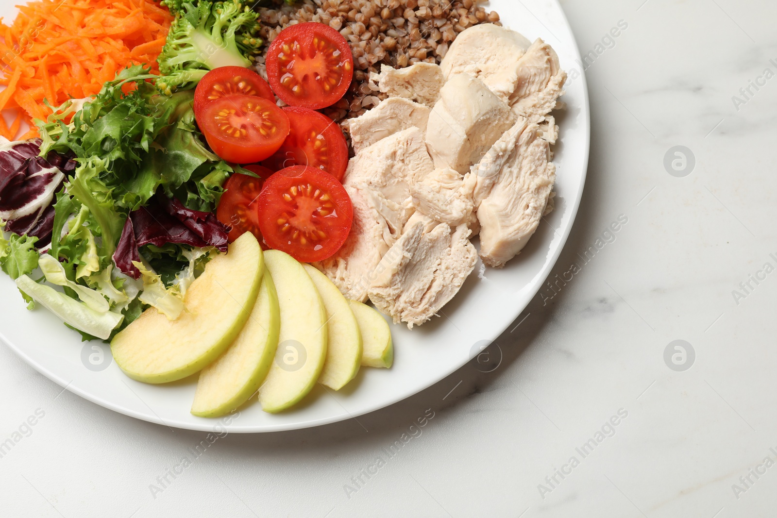 Photo of Balanced diet and healthy foods. Plate with different delicious products on white marble table, top view