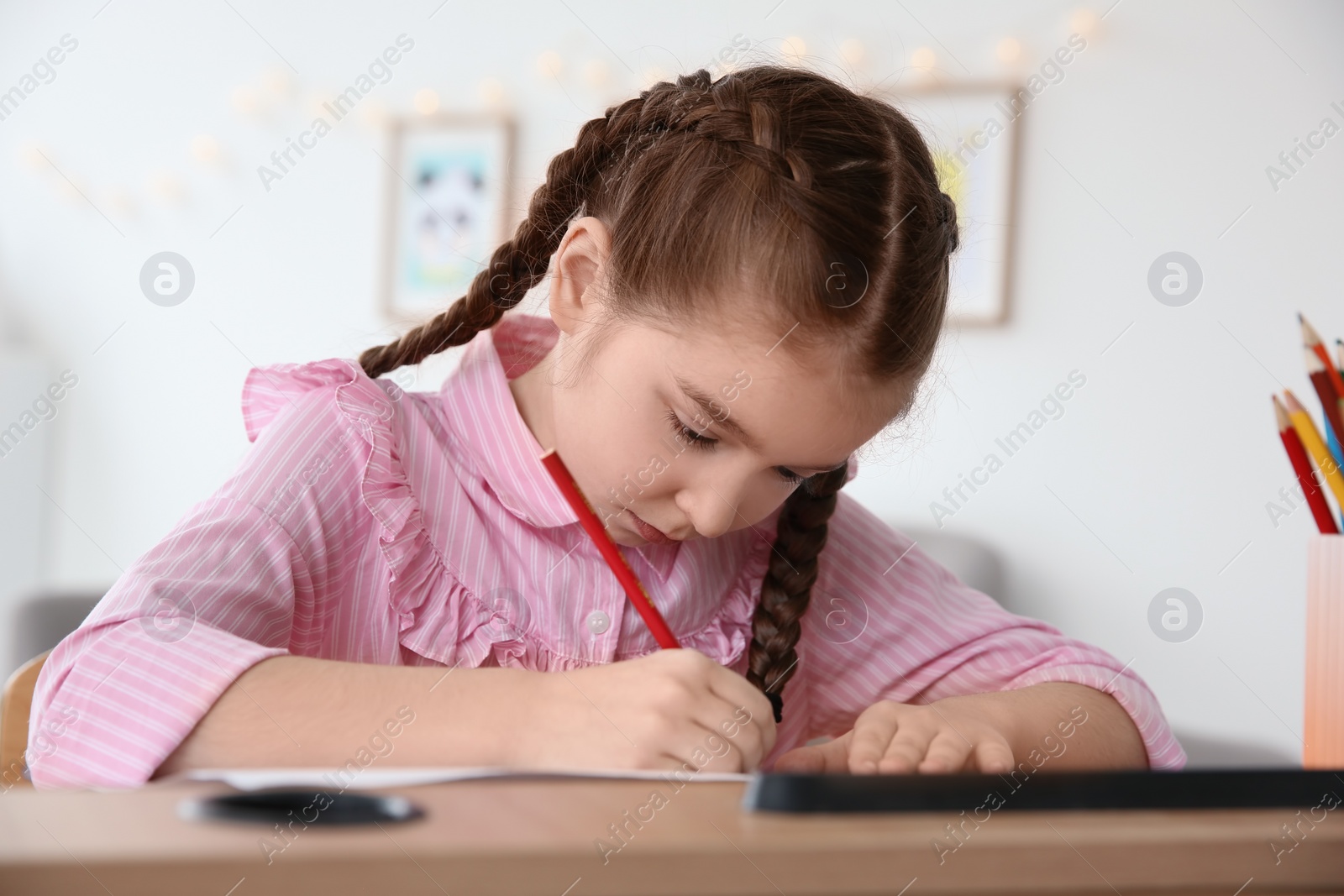 Photo of Little girl with autistic disorder drawing at home