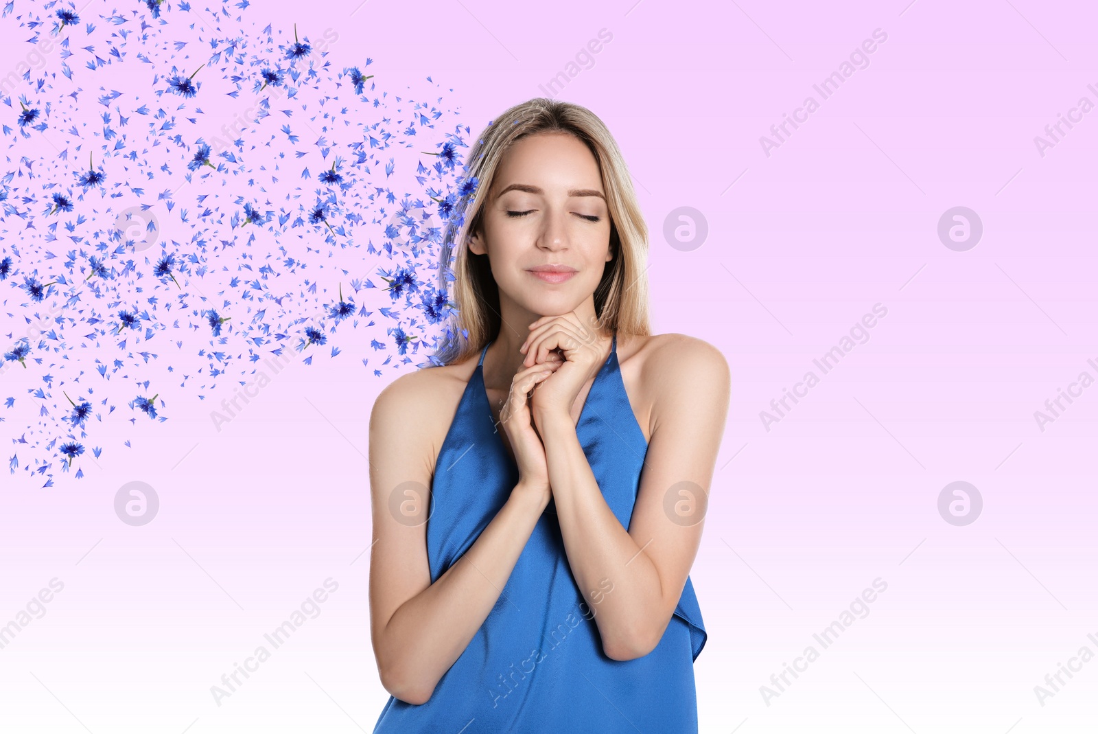 Image of Beautiful young woman with closed eyes on pink background. Flowers and petals flying from her head symbolizing state of mindfulness