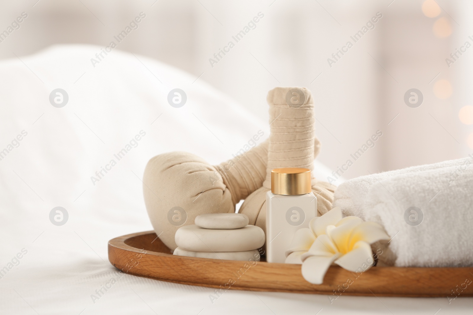 Photo of Beautiful composition with spa stones on white fabric