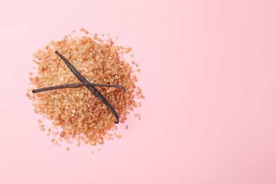 Photo of Pile of brown vanilla sugar on color background, top view