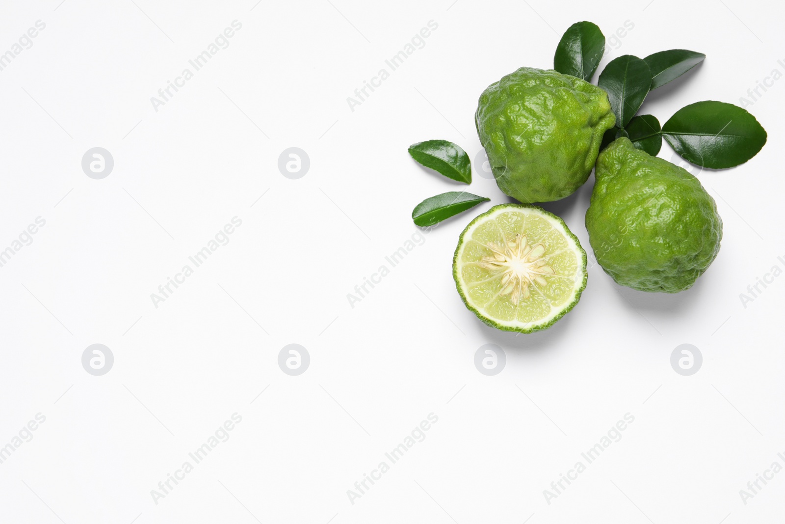 Photo of Flat lay composition with ripe bergamot fruits on white background. Space for text