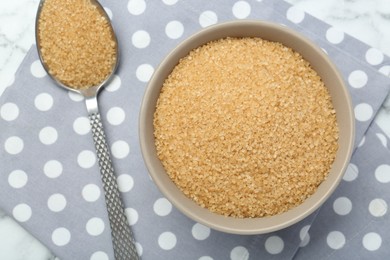 Photo of Brown sugar in bowl and spoon on table, top view