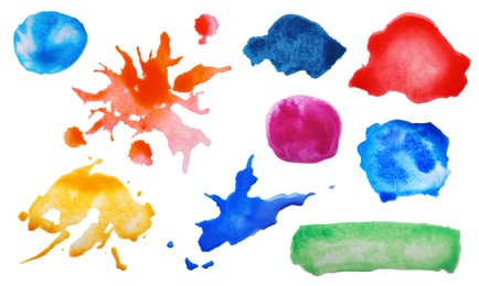 Set with colorful blots of ink on white background, top view