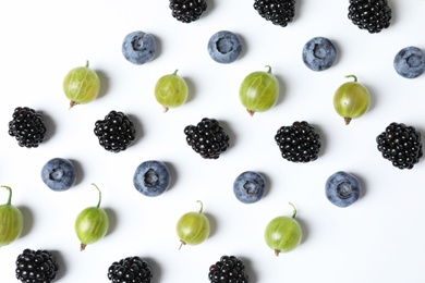 Composition with gooseberries, blackberries and blueberries on white background