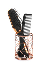 New modern hair brush and comb in metal holder isolated on white