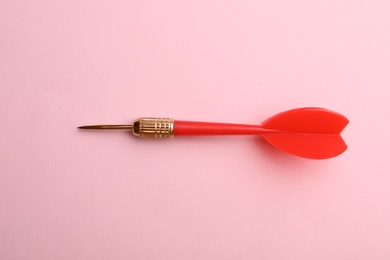 Red dart arrow on pink background, top view