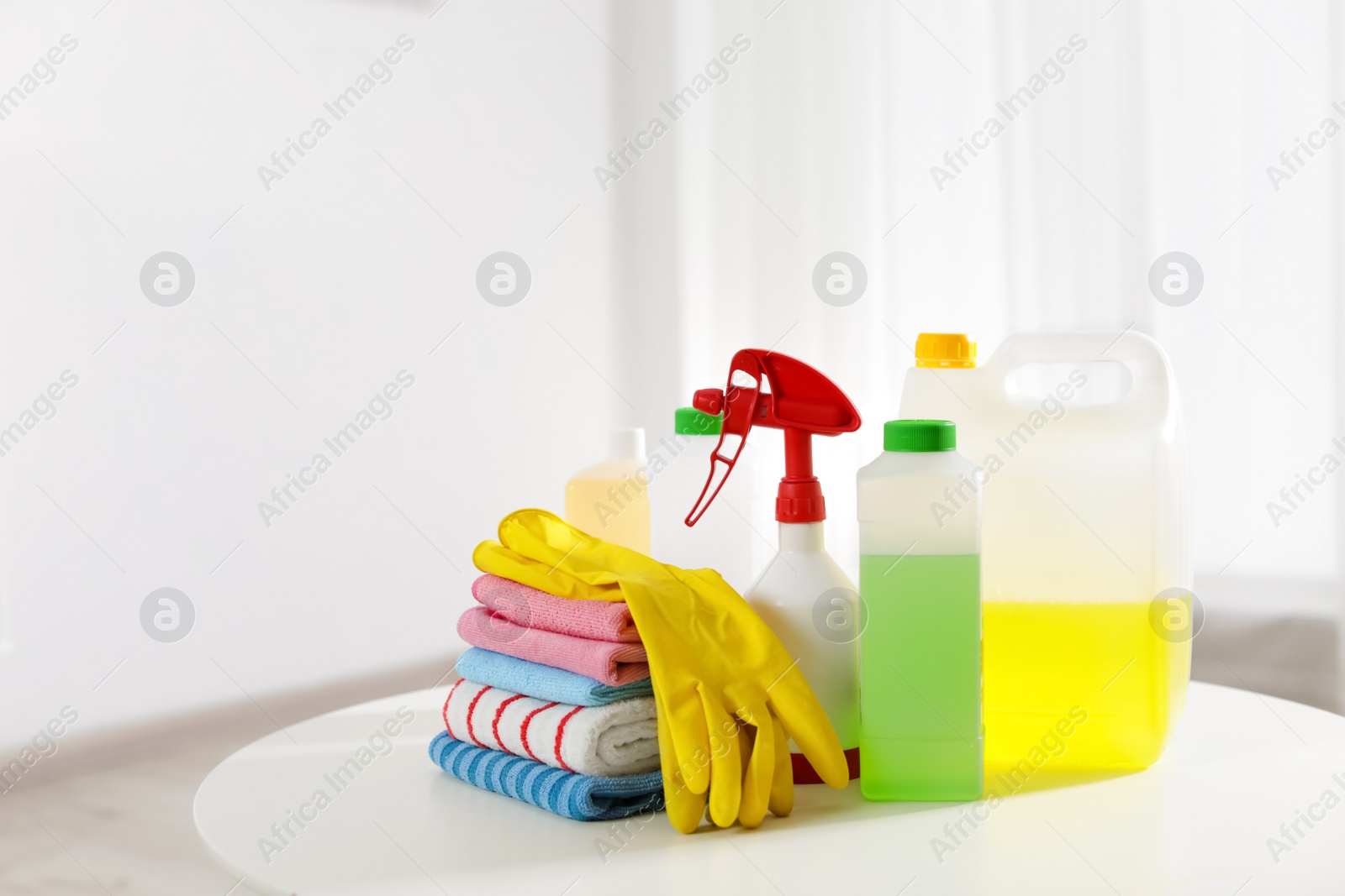 Photo of Set of professional cleaning supplies on table indoors. Space for text