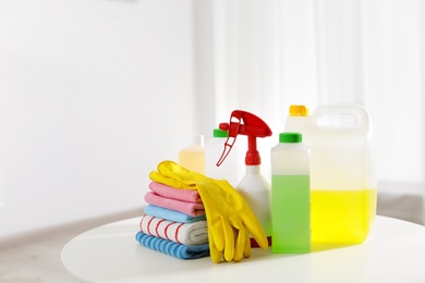 Set of professional cleaning supplies on table indoors. Space for text