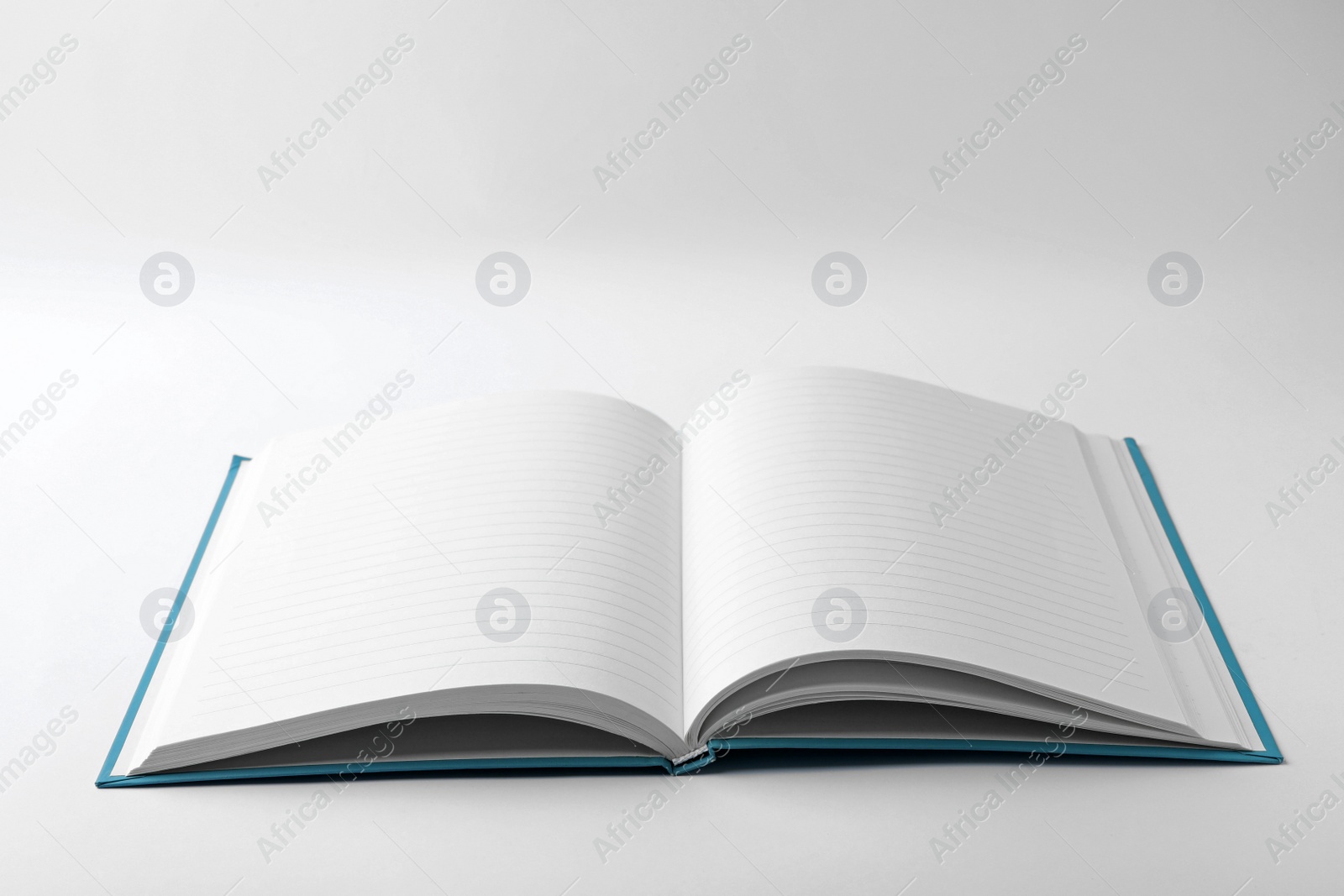 Photo of Stylish open notebook with blank sheets isolated on white