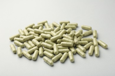 Photo of Vitamin capsules on light grey background. Health supplement